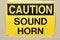Closeup of a Caution Sound Horn warning sign