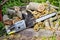 Closeup of chain saw lies on the background of sawn walnut logs