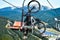 A closeup of chair on the ski lift in mountains and forest. cable car boy transporting his bike on mountain