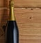 Closeup of a champagne bottle in a wood crate with copy space