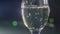 Closeup of champagne flute, abstract lights background, focus on bubbles