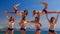 closeup cheerleaders demonstrate stunt Swedish falls on beach