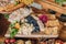 Closeup of a cheeseboard with a selection of cheese, blueberries and fresh bread