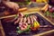 Closeup of Chef hands serving beef steak