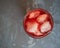 Closeup of cherry lemonade with ice in a glass goblet