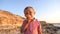 Closeup, child boy eating a bun. Real emotions, boy on a sea coast background