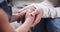 Closeup of child daughter holding adult foster care mother hands