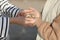 Closeup of child girl& x27;s hands giving many seashells to her young mother with love and tenderness. child and parents