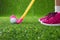 Closeup of a child golfer with putter and ball