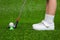 Closeup of a child golfer with putter and ball