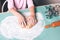 Closeup of child hands kneading fresh dough on the table for Christmas gingerbread cookies with rolling pin