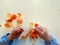 Closeup of child hands peeling fruit wearing school uniform - learning by doing, education, kindergarten, snack time concept