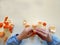 Closeup of child hands peeling fruit wearing school uniform - learning by doing, education, kindergarten, snack time concept