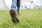 Closeup of child leg and boot sole on grass