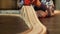 Closeup of child playing on floor with wooden railroad and colorful toy train.