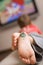 Closeup of child`s foot with button drawing on it. Boy watching TV. Children and technology