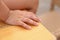 Closeup of a child\'s hand sitting on a desk,