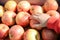 Closeup of child\'s hand taking apple. Store display full of red yellow apples on purple box.