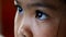 Closeup children eye looking computer