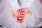 Closeup children`s hands holding Christmas gingerbread in form of caramel can.