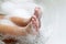 Closeup of childs feet washing in bathroom with shampoo foam on
