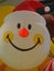 Closeup Christmas Santa Claus Smiley face yellow ball balloon