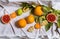 Closeup of citruses isolated on the white fabric - grapefruit, orange, lemon, tangerine