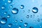 Closeup of clear water drops, dew or dripping rain isolated on blue background