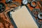 Closeup clipboard with vintage paper in the center of tools, gears on metal background. Motorcycle tools, equipment and repair