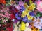 A closeup cluster of very colorful artificial flowers on display for sale