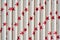 Closeup of cocktail paper straws with red stars design. Recyclable organic tubes