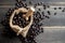 Closeup Coffee beans in bag made from burlap on wooden surface and wooden shovel lying in a sack. Fresh coffee beans and bag on ol