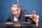 Closeup of coins on weighing scale with businessman in background