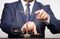 Closeup of coins on weighing scale with businessman in background