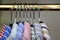 Closeup of collars of men\'s shirts hanging on a rail