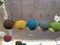 Closeup of colorful baskets with chains hanged from a thread at an open-air market