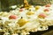 Closeup of colorful Brazilian fudge balls (truffle) lined up in the golden tray, on the glass table