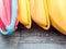 Closeup of colorful canoes on wooden floor