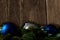 Closeup of colorful Christmas ball ornaments attached to a garland placed on a wooden surface