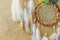 Closeup colorful dreamcatcher details on striped craft wrapping paper background
