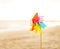 Closeup on colorful windmill toy on the beach