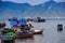 closeup colourful fishing boats in azure sea against island