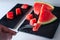 Closeup of a composition of fresh fruit of the summer, watermelon on white background with slate. Mediterranean diet with varied