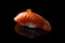 Closeup composition of fresh salmon sashimi sushi with caviar on black background