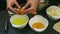 Closeup confectioner hands breaking up two raw eggs separate yolk from protein