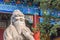 Closeup of Confucius statue in front of colorful ancient temple with beautiful ornaments