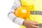 Closeup of a constructor holding yellow worker hat underarm