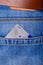 Closeup of contactless credit card peeking out of blue jeans back pocket