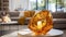 A Closeup of a Contemporary Amber Glass Sculpture Showcased in Front of a Stunning, Modern Living Room