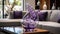 A Closeup of a Contemporary Plum Purple Glass Sculpture Showcased in Front of a Stunning, Modern Living Room